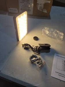 lot 4158 image: M160 panel light with a rechargeable battery and a clip-on mount