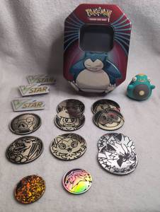 lot 703 image: Pokmon Snorlax Metal Tin with Collectible Coins and VSTAR Markers Set