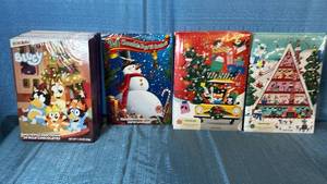 lot 2029 image: Christmas Advent Calendar Collection with Milk Chocolates. 11 Bluey.1 Snowman.2 Red. 2 Blue