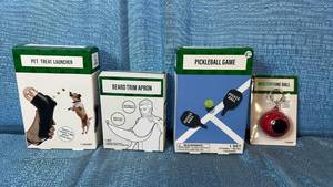 lot 2147 image: Novelty Gift Set - Pet Treat Launcher, Beard Trim Apron, Pickleball Game & Fortune Ball