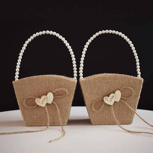 lot 2623 image: STAFUNI Rustic Burlap Flower Girl Baskets with Pearl Handle,Bow Knot Heart Petals Flower Basket for Vintage Wedding Ceremony, Set of 2 - Retail $17