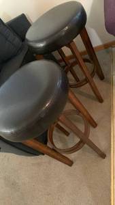 lot 915 image: Ashley Furniture Wooden Bar Stools with black Seats, one needs repair 30X16