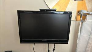 lot 1326 image: Dynex LCD HDTV with Remote Control - 23 inch Comes with a bracket mount, which youll need to remove from the wall