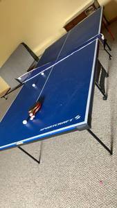 lot 2000 image: Sportcraft Blue Ping Pong Table Tennis Table with Net and Paddles located in basement 30X108X60