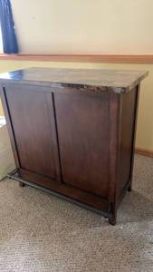 lot 2002 image: Stone Top Storage Console with cubbies 41X42X20 located in basement
