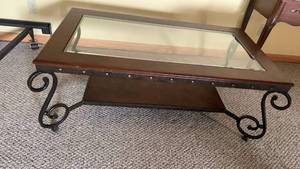 lot 2012 image: Glass Top Coffee Table with Wrought Iron Scrollwork Base 19X50X28 located in basement