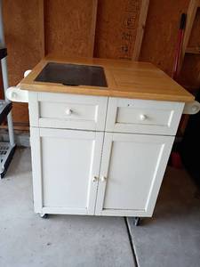 lot 3218 image: Rolling Kitchen Island.  Needs cleaned.  Lots of storage and granite slab on top.  37 x 40 x 33, side up.  37 x 40 x 22, side down