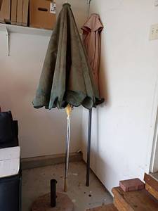 lot 3221 image: 2 Patio Umbrellas and a Stand.  Stand is made of marble or granite.   Stand is 16.5 x 16.5