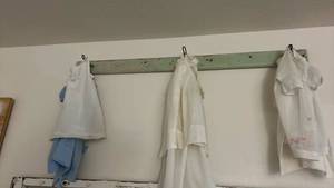 lot 104 image: Embroidered White Cotton baby clothes  with Lace Trim Collection and primitive hanger