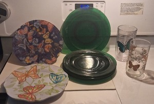 lot 88 image: Glassware Set Emerald Green Plates, Butterfly Tumblers, and Decorative Accents