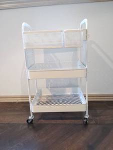 lot 1027 image: White Metal Rolling Storage Cart 27x12x16 in Located in Basement