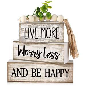 lot 6400 image: Moucuny 4 Pcs Inspirational Farmhouse Table Decor Rustic Stacked Wooden Block Sign - Live More Worry Less Be Happy Centerpieces Set with Beaded Tassel and Artificial Plant for Home, Office, Shelf Gift