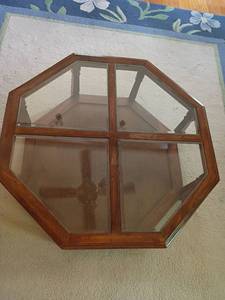 lot 915 image: Wooden Octagon Shaped Coffee Table with Glass Top and Bottom Shelf.  15 x 38 x 38.  Top needs stained