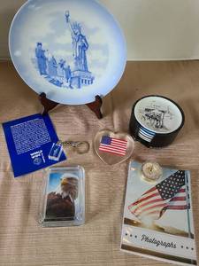lot 1039 image: Statue of Liberty decorative plate, glass ash tray with Eagle picture, acrylic American Flag paperweight, more.