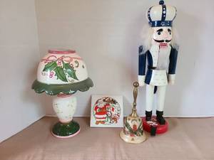 lot 1049 image: Christmas holiday decorations, including brass bell and 15in tall nutcracker with loose shoe and peeling paint on base