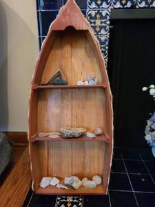 lot 1053 image: Wooden boat shaped display shelf with contents, 32in tall
