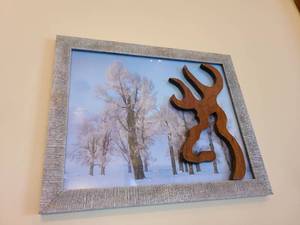 lot 1056 image: Framed wall decor with a wooden Browning logo attached to the glass, 13x16