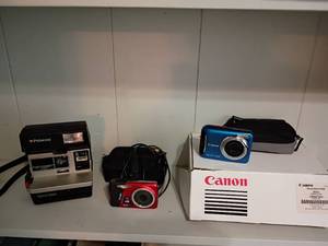 lot 1210 image: Cameras.  Polaroid, Cannon and Kodak