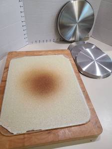 lot 1407 image: Stainless steel burner covers, 3 small and one large, cutting boards.