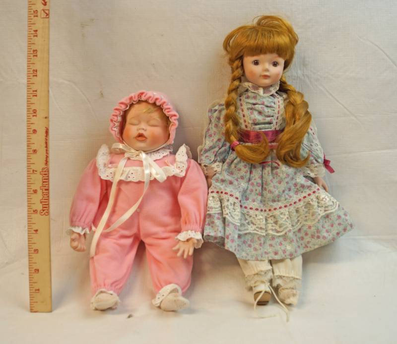 lot 6287 image: Two collectible Porcelain dolls-Adorable sleeping baby and big sis-One marked Heritage Mint LTD on neck-See pics for other markings and size.