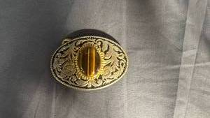 lot 95 image: Gold Tone Ornate Belt Buckle with Tigers Eye Stone