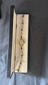 lot 118 image: Gold Tone Womens Bracelet Watch with Blue Stones