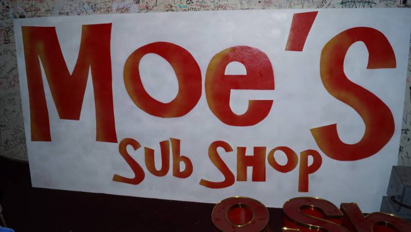 lot 1156 image: Moes Sub Shop Sign - 4 x 8 - A Piece of History Here