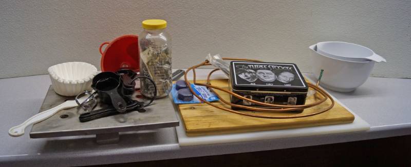 lot 1192 image: 3 Stooges Collectible Lunch Box, copper wire, cutting board, kitchenware & more