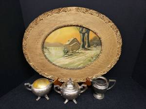 lot 96 image: Antique Water Wheel River Print in Custom Made Gold Painted Wood Oval Frame with Gesso Embellshment - 19in W x 15in T, and 3 Silver Plate Servers - 2 Creamers & 1 Lidded Sugar