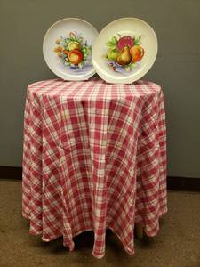 lot 108 image: Round Wood Decorator Table 20in W x 26in T with Pink Check Cloth and 2 1960s Hand Painted Porcelain Plates with Gold Trim - By T.M.J. with Original Stickers