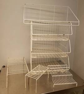 lot 126 image: White Wire Wall Shelf with Hanger Bar 24in W x 12in D x 10in T, Stackable 3pc Basket Tray Stirage Unit 25.5in T Stacked, and 3 Cabinet Shelf Risers