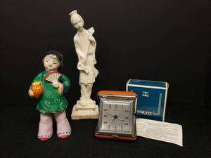 lot 159 image: Vintage 1970s-80s Equity Wind-Up Travel Alarm Clock Model #9185 in Tan Case - Glow-in-the-Dark-Hands - Works - In Original BoxPackaging - With Instructions, and 2 Vintage Porcelain Asian Figurines Girl wtih Fan and Musician