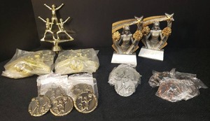 lot 17 image: NewUnsuded Cheer Squad Pyramid Gold Trophy Top Figurines - 3 Pcs 6in T with 2 still sealed in Original Pagages, 2 New Unused Cheerleader Trophies 5.5in T, and NewUnused Cheer Medals 10 Gold, 7 Silver, 5 Bronze