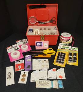 lot 31 image: Red Sewing Case with Removable Inner Tray & Various Sewing Supplies Buttons, Thread, Metal Bobbins, Scissors, Needles, Rotary Cutter, Pinking Shears, Velcro, Iron-On Adhesive, Ribbon, and Rit Tint and Die