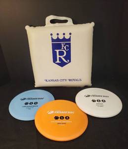 lot 38 image: Original Frisbee Disc Golf Discs - White Putter, Orange Mid-Range Approach, & Blue Long Range Driver, and Vintage Kansas City Royals Vinyl Seat PadCushion 12.5in x12.5in