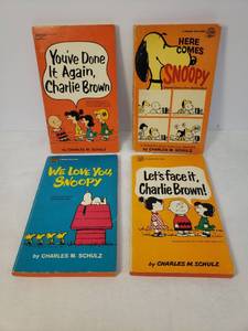 lot 68 image: Vintage Lot of Charlie Brown Paperback Books by Fawcett Crest 1960 Lets Face it Charlie Brown, 1962 We Love You, Snoopy, 1969 Here Comes Snoopy, and 1970 Youve Done It Again, Charlie Brown