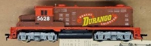 lot 71 image: Vintage 1976 TYCO HO Scale Electric Train Set - #7318 - Includes Power PackTransformer, Oval Track, Engine with Headlight, Flood LIght Caboose, and 4 Train Cars, with Cattle Truck, Cows and Unloading DepotCorral Set - in Original Box Base - NO Box Top