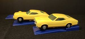 lot 90 image: Vintage 1973 Proctor & Gamble Funmate Auto Toys - 2 Yellow Mercury Montego GT Cars - with 3 Working Spring Action Launcher Ramps