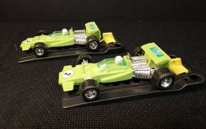 lot 91 image: Pair of Vintage 1970s Proctor & Gamble Funmate Plastic Auto Toys - 2 Formula 1 Race Cars - #2 Lime Green, and 2 Rubber Band Action Launchers - They Work, but will need new bands