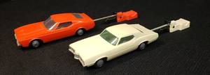 lot 104 image: Pair of Vintage 1970s Proctor & Gamble Funmate Go Cars Toys 5in L - with Spring Action Launching Tools Orange Ford Mustang & White Ford Thunderbird