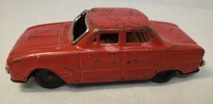 lot 108 image: Vintages 1940s-1950s Pressed Red Tin Lithograph 4 Door Sedan - Friction Drive Mechanism - 5.5in L x 2.25in W