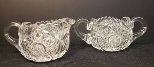 lot 129 image: Antique Libbey Signed American Brilliant Cut - Heavy Crystal Cream & Sugar Set - Pentagon Hobstar Cut Design with Starburst Bottoms - Double Handles on Sugar 7in W, Creamer 5.75in W