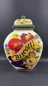 lot 23 image: Ceramic Nonnis biscotti jar features a hand-painted fruit motif and stands approximately 12.5 inches tall