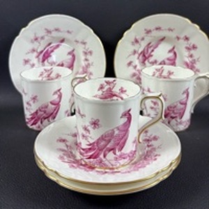 lot 106 image: Royal Crown Derby bone china (3)demitasse cups feature an intricate red pheasant pattern and delicate gold trim. (4) Saucers