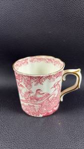 lot 107 image: Royal Crown Derby Red Aves bone china demitasse cup features an intricate red pheasant pattern and delicate gold trim.