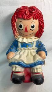 lot 134 image: Raggedy Ann Bank with Red Hair and Blue Dress
