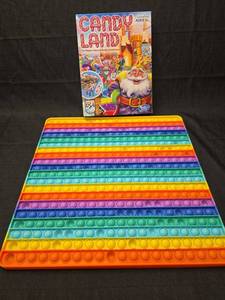 lot 50248 image: Candy Land Board Game and Rainbow Pop It Fidget Toy Set
