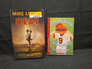 lot 50170 image: Two Baseball Themed Books - Heat by Mike Lupica and Out Standing in My Field by Patrick Jennings