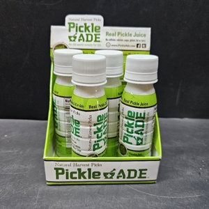lot 3087 image: PickleAde Real Pickle Juice Shots with Turmeric, 3oz (4 Pack)  Electrolyte Pickle Juice Sports Drink  Kosher Pickle Shots  Pickle Brine for Muscle and Leg Cramp Relief. No printed expiration or best-by date.