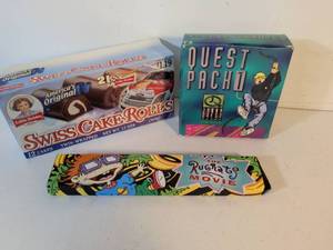 lot 19 image: 90s Video Game Promotional Items Bundle - Quest Packt, Swiss Cake Rolls box is empty, Rugrats Movie